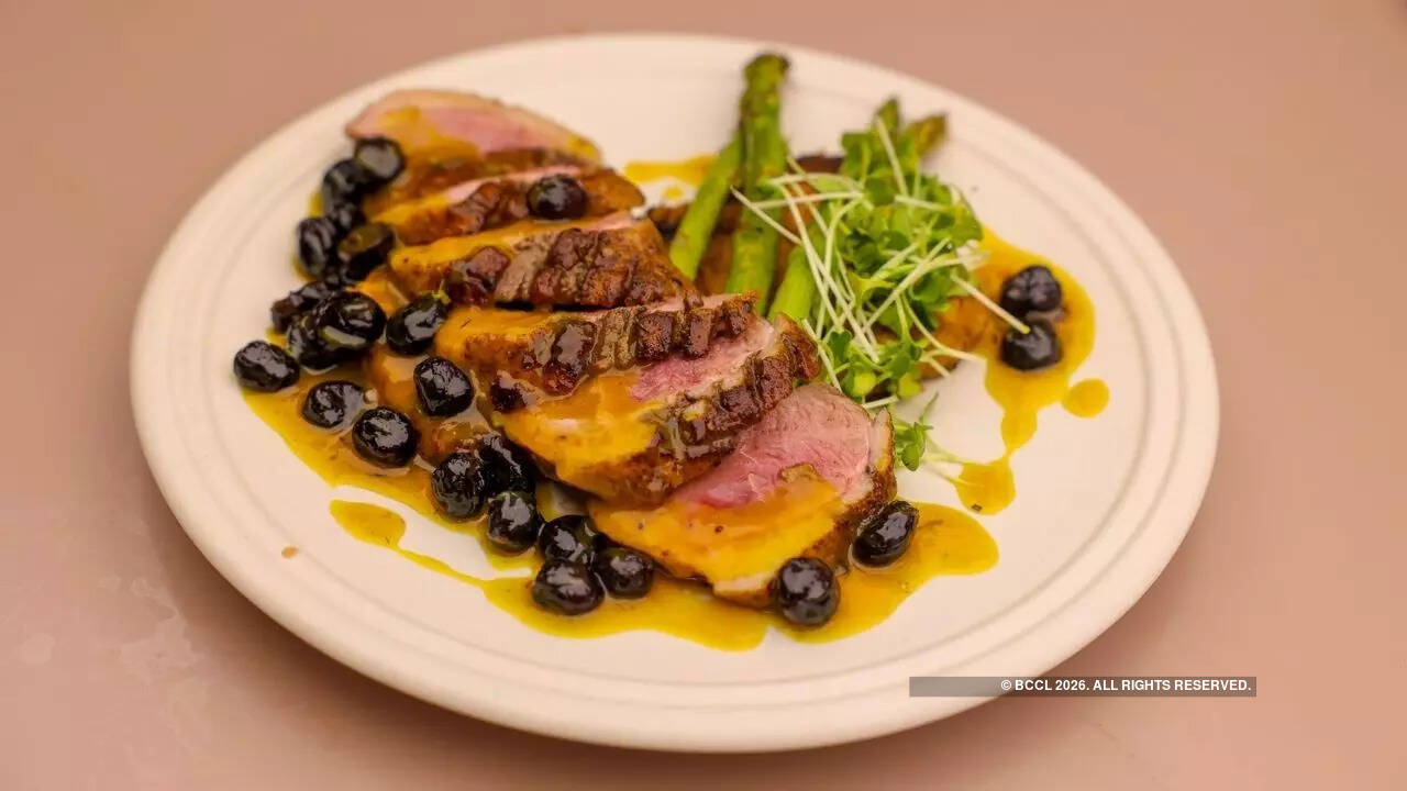 Duck breast with a cranberry and orange sauce, asparagus and a sweet potato galette<br>