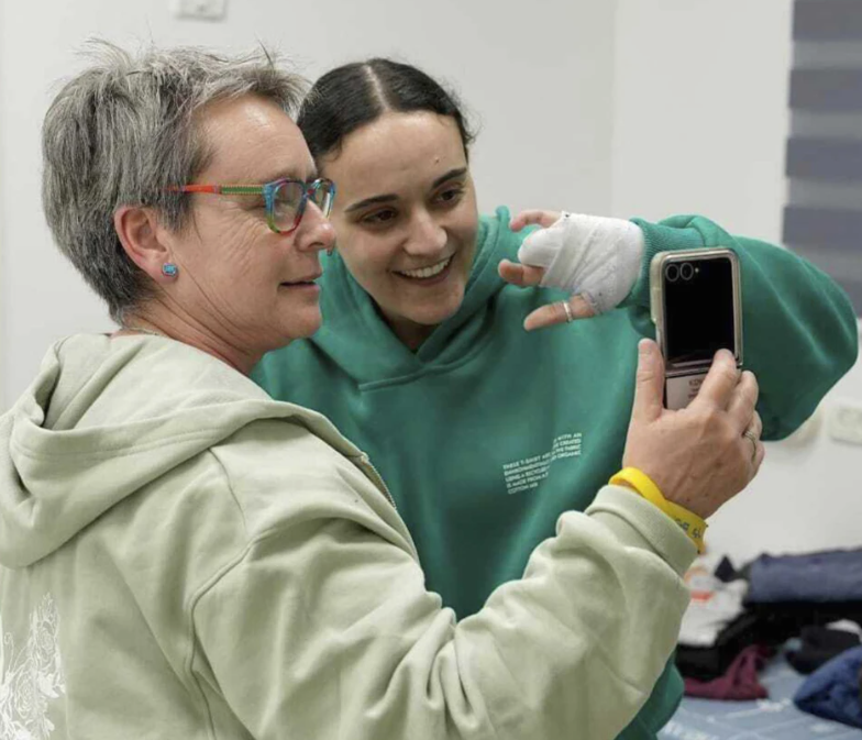 Released Israeli hostage Emily Damari (in green) and her mother
