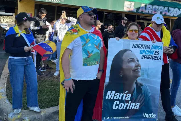 Venezuelans in Florida, celebrating Nicolás Maduro’s capture with a banner of opposition leader and Nobel Peace Prize winner Maria Corina Machado.