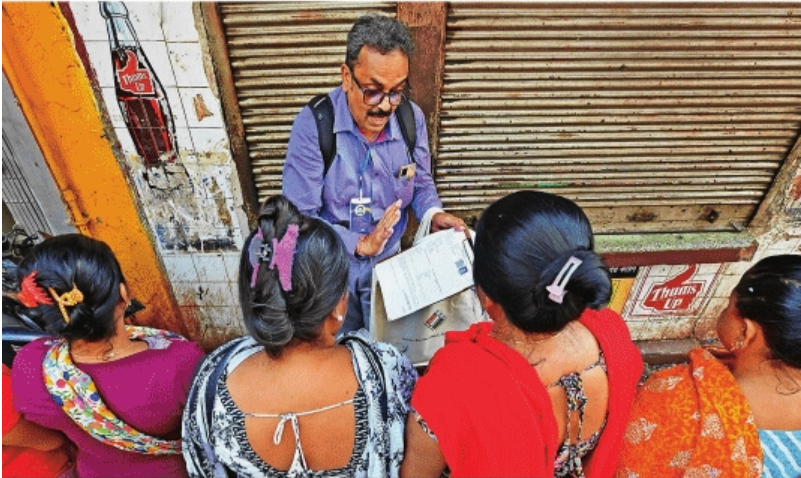 An official explains the SIR form to sex workers in a red light district in Kolkata