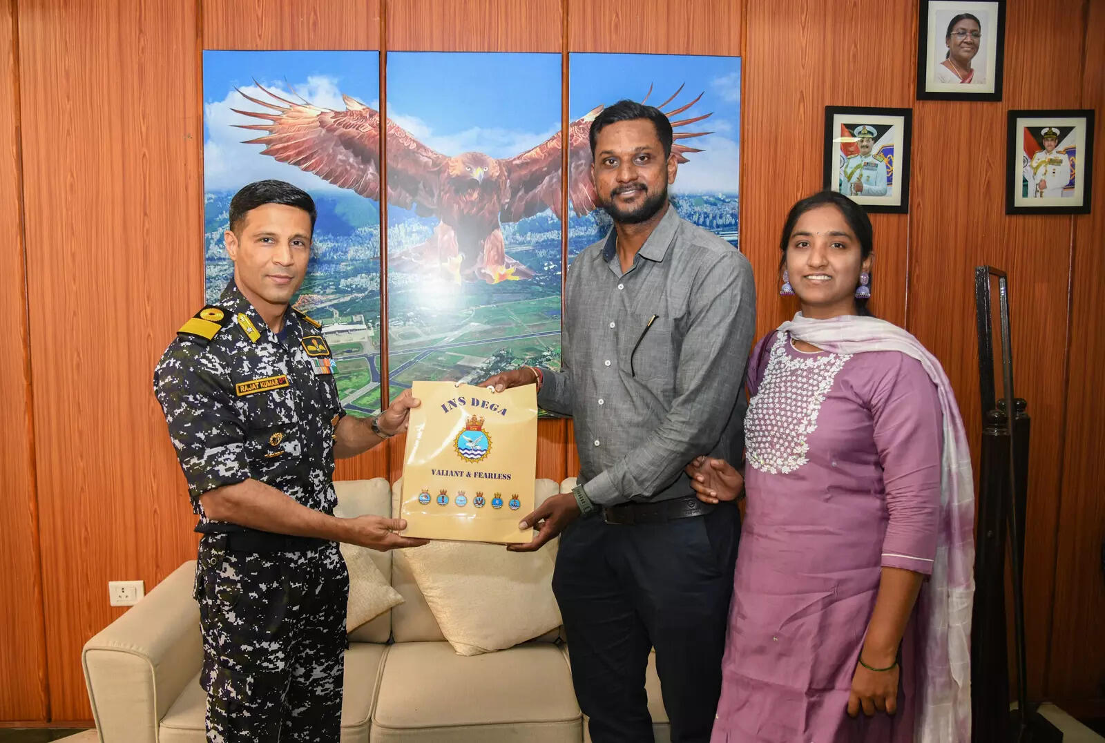 A contest winner from Visakhapatnam receives naval memorabilia from the Commanding Officer of INS Dega