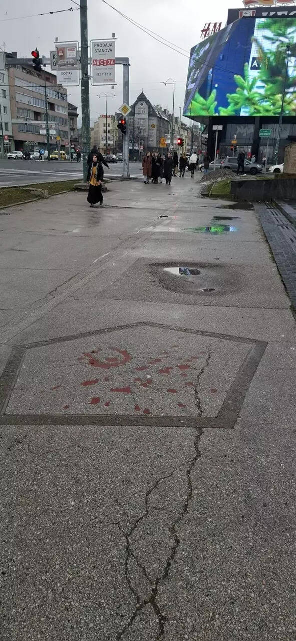Marks of artillery shells from the war, marked on pavement in Sniper Alley in Sarajevo. The locals call the shapes 'Sarajevo Roses' (PC- Elza, Sarajevo, Jan, 2026)