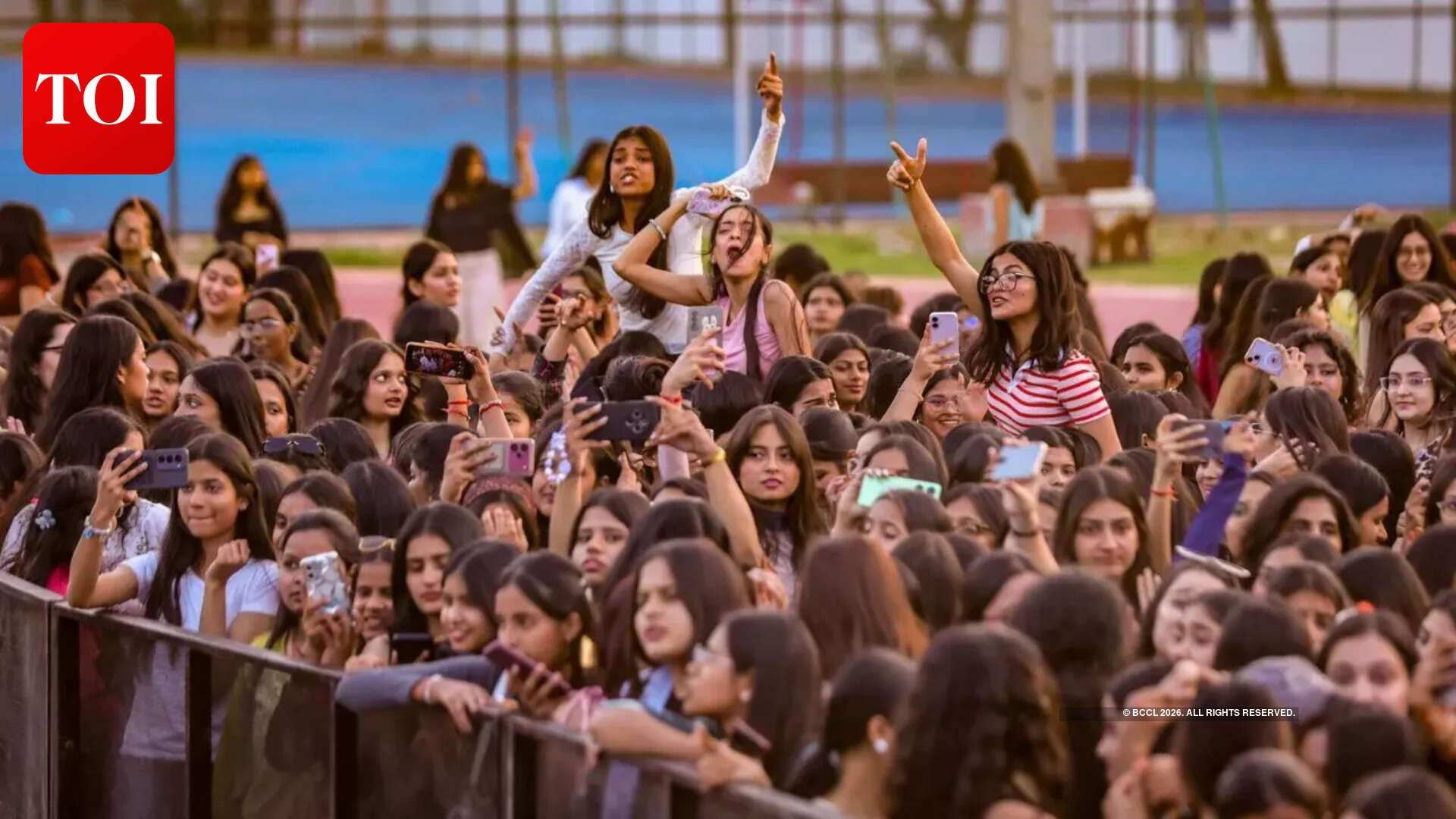 Students enthusiastically climbed onto their friends’ shoulders for a better view Students enthusiastically climbed onto their friends’ shoulders for a better view