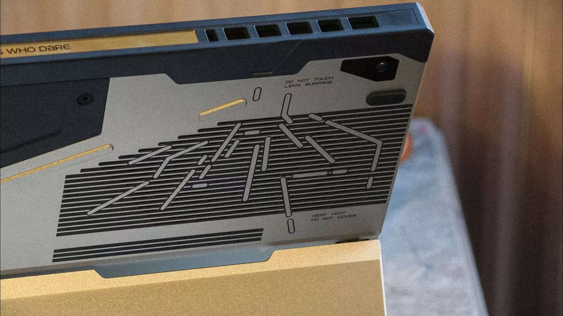 Laser-etched vents styled like safety markings on a spacecraft hull<br>