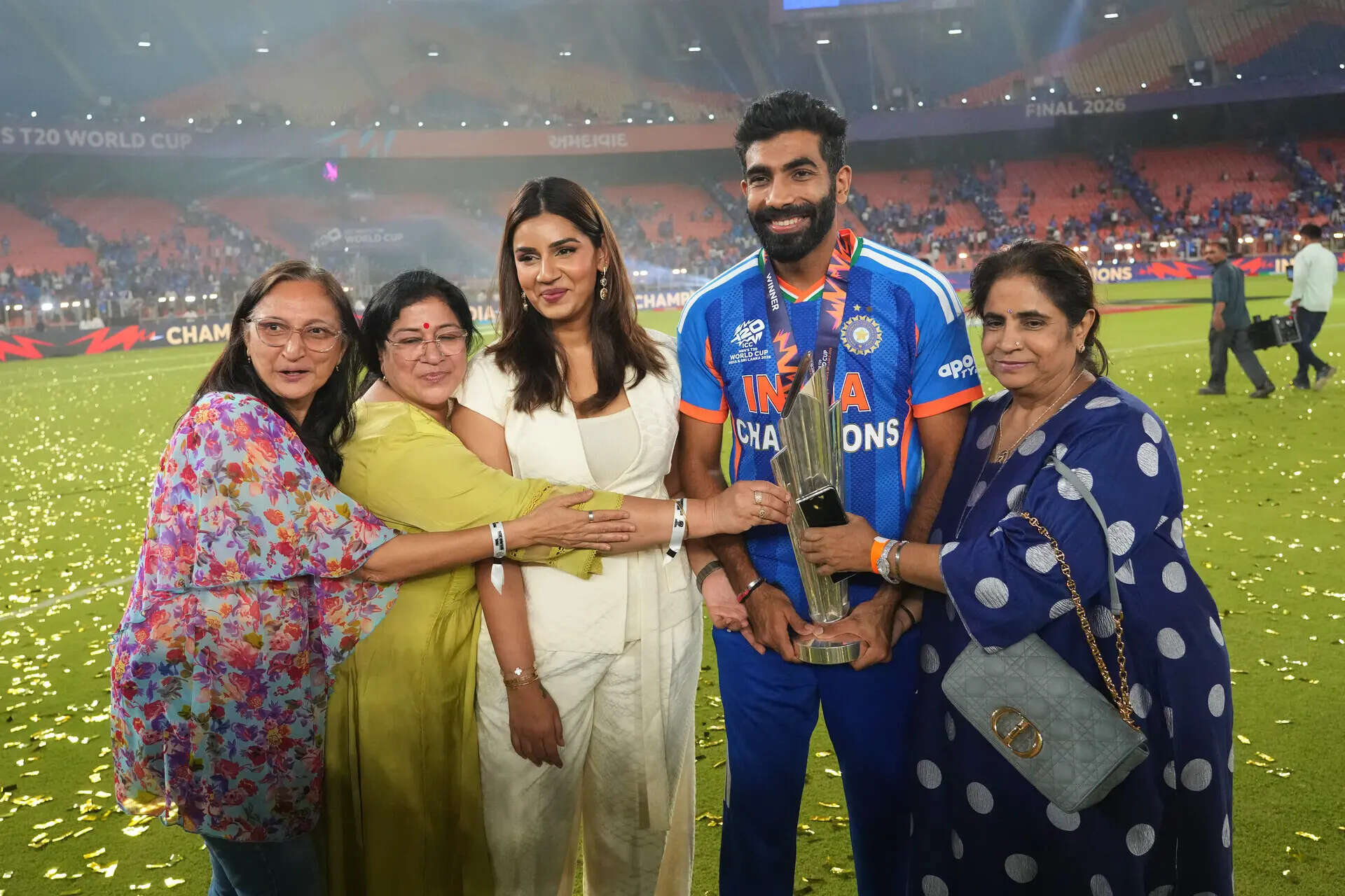 India's Jasprit Bumrah holds Trophy and poses for photograph with his family members after winning the T20 World Cup final match against New Zealand, in Ahmedabad, India, Monday, March 9, 2026. (AP Photo/Rafiq Maqbool) India New Zealand T20 WCup Cricket