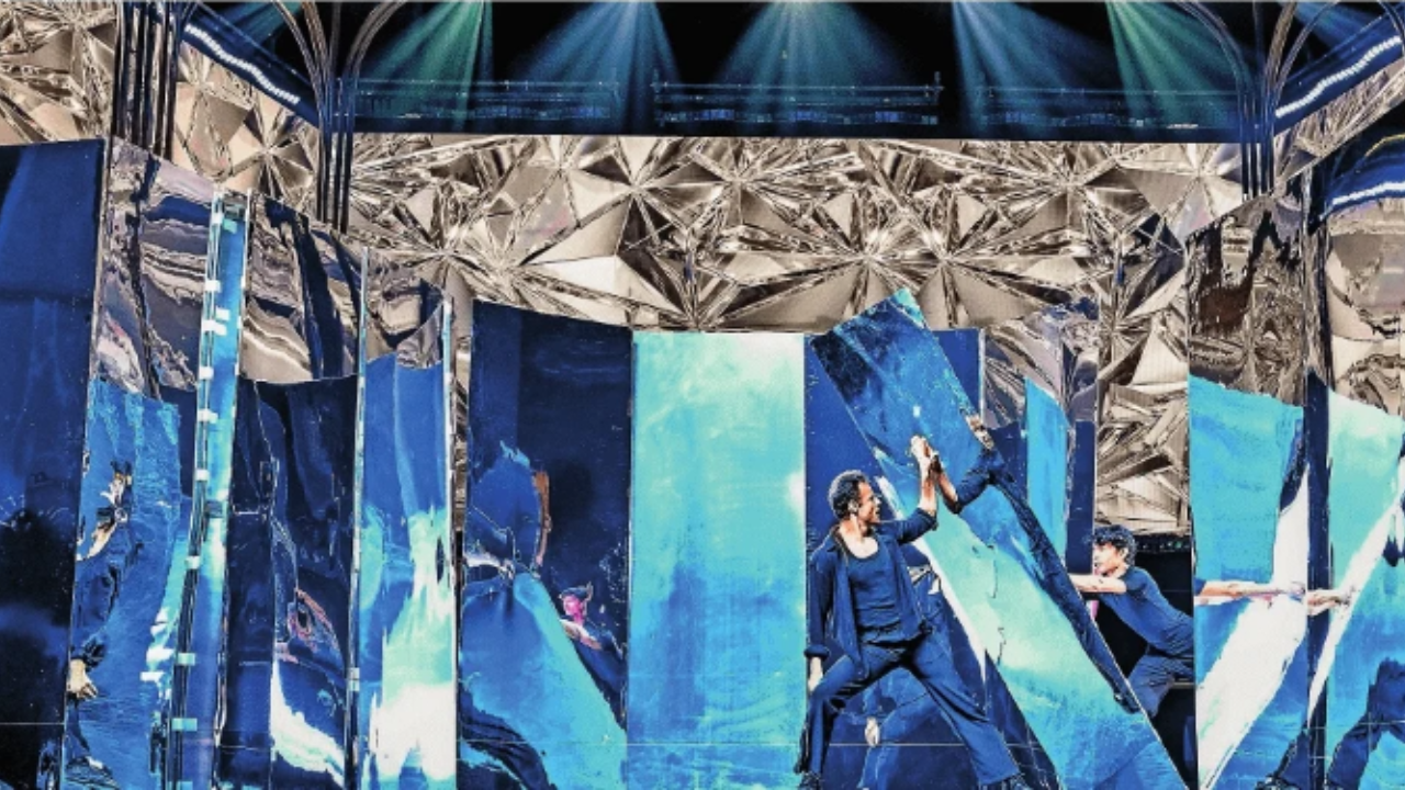 Puneet, the lead male dancer, is holding the mirror.