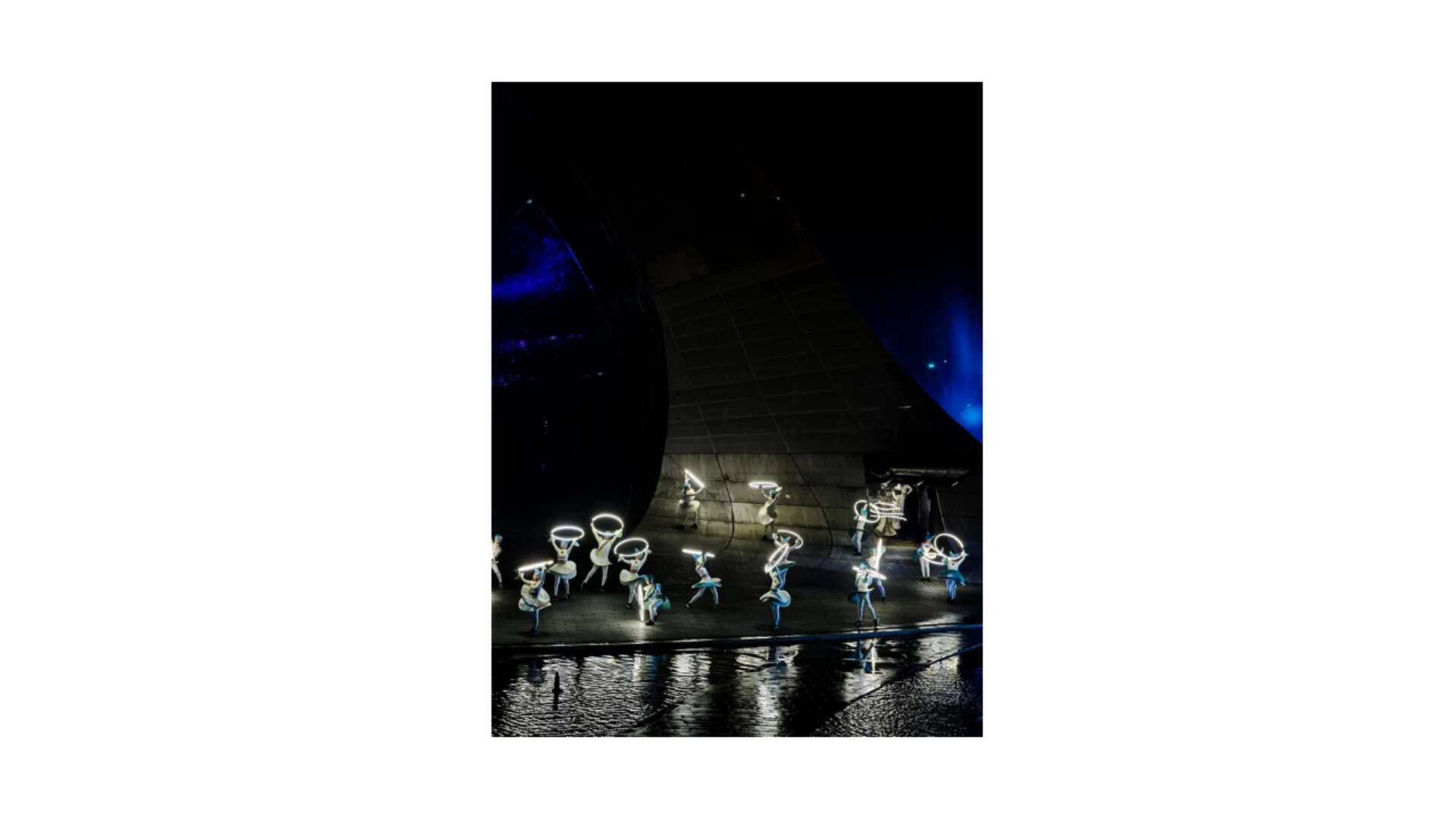 Shot from a distance, the telephoto held the scale of the arch and the detail of the performers at the same time