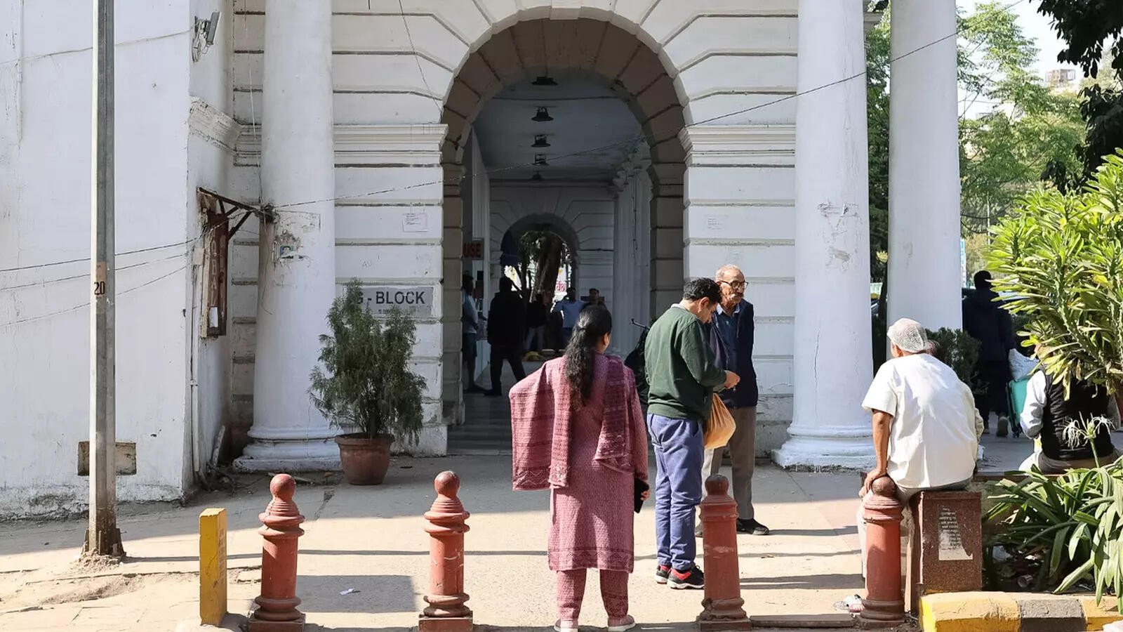 Connaught Place, midday. Blown whites and deep shadows in the same frame—the shot held detail in both