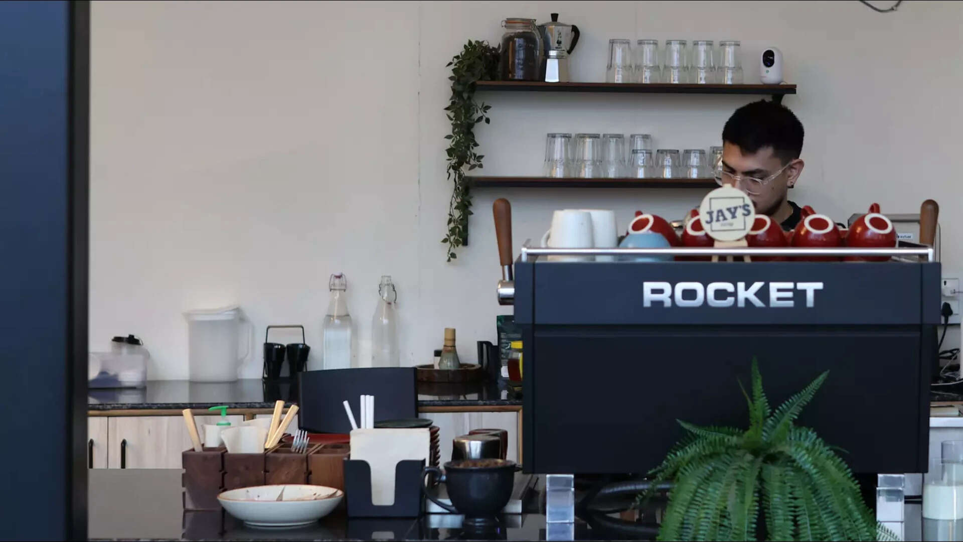 Indoor available light at a coffee shop. Colour and shadow detail intact without aggressive ISO push.