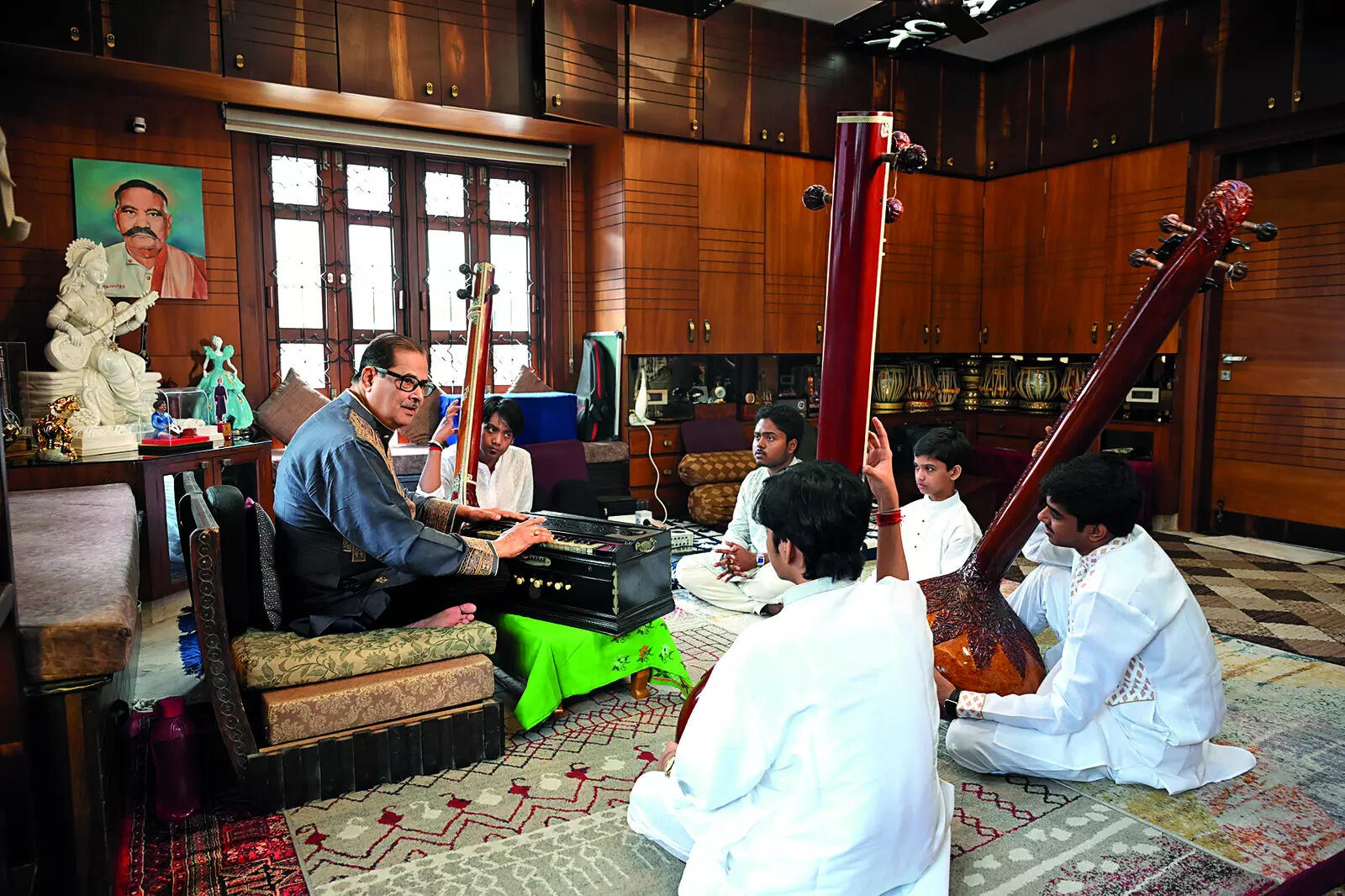 Pt Ajoy Chakrabarty, an exponent of the Patiala-Kasur gharana sits beneath a portrait of Bade Ghulam Ali Khan, who heavily influenced his gayaki P1_SS_7687