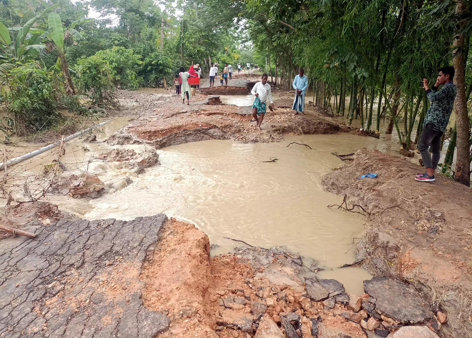 Nagaon, May 21 (ANI): A damaged road in a flood-hit area of Hojai in the Nagaon ...