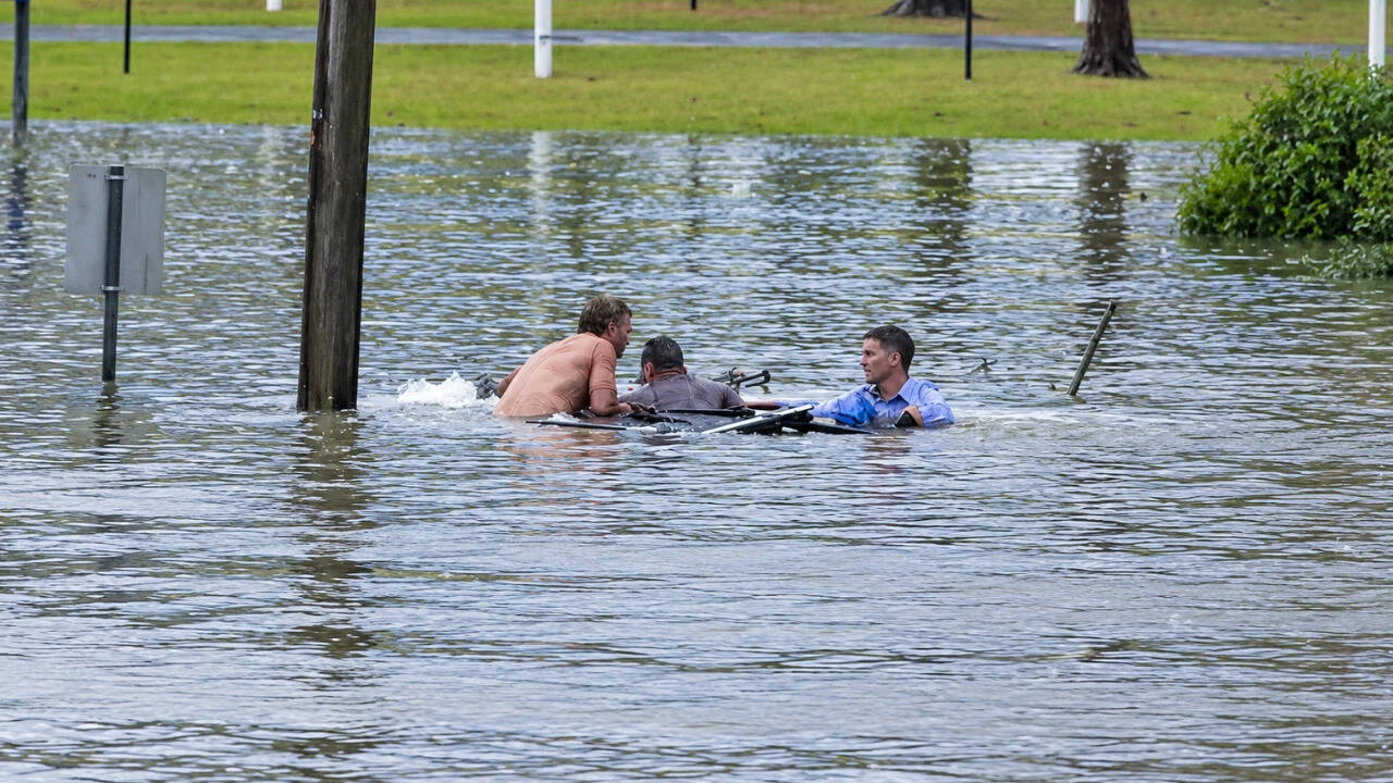 Australian reporter and bystander rescue driver from flooded Ccar