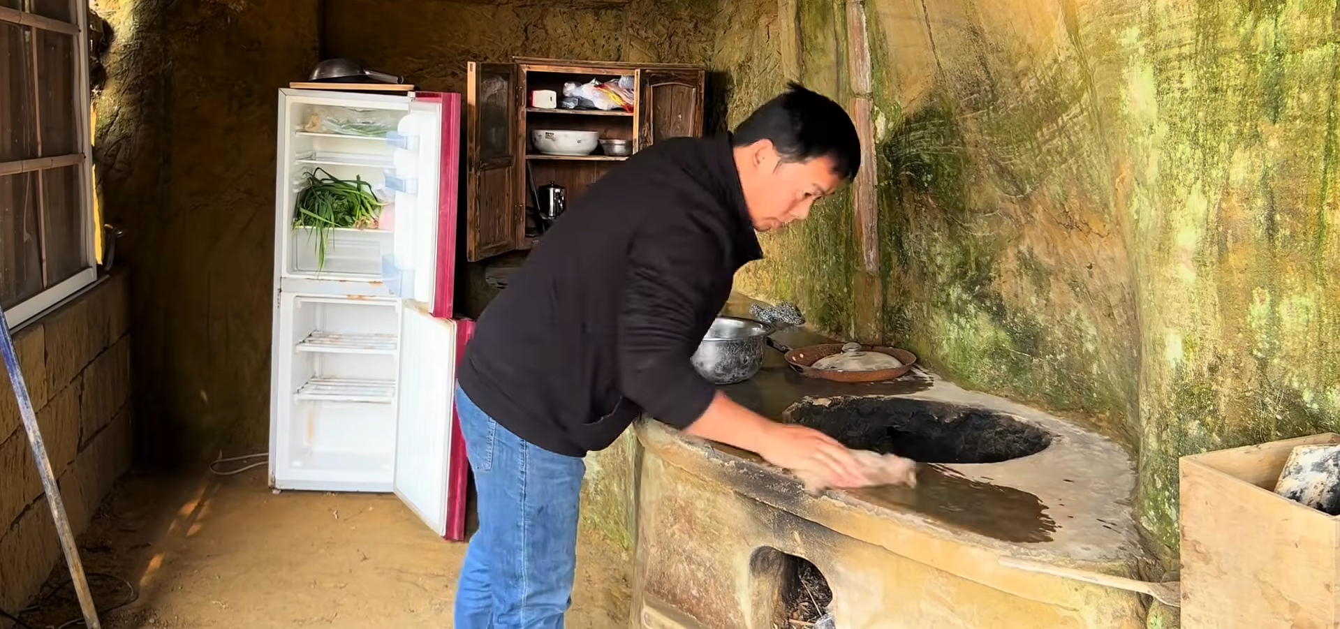 The kitchen is carved directly into the mountain, with rock-cut counters and built-in features designed to make the remote home fully functional.