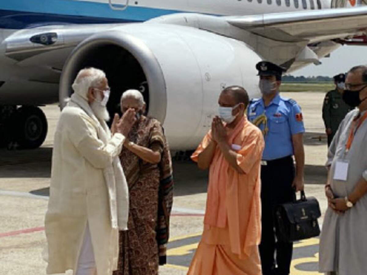 Prime Minister Narendra Modi being received at the airport by Uttar Pradesh governor Anandiben Patel, CM Yogi Adityanath, and other dignitaries, in Varanasi on Thursday. (ANI photo)