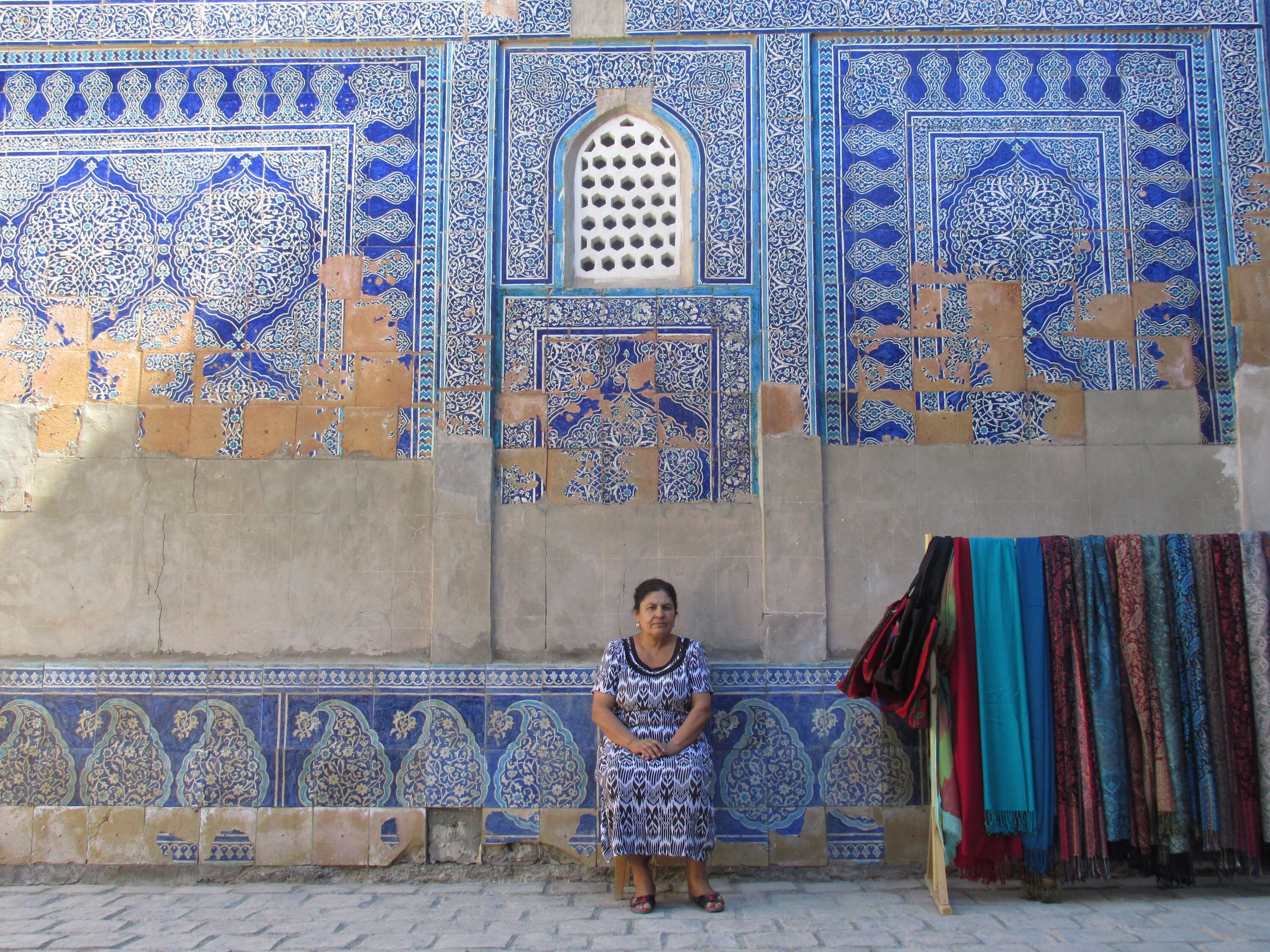 A carpet seller inside the Tosh Hovli Palace, in Khiva, Uzbekistan
