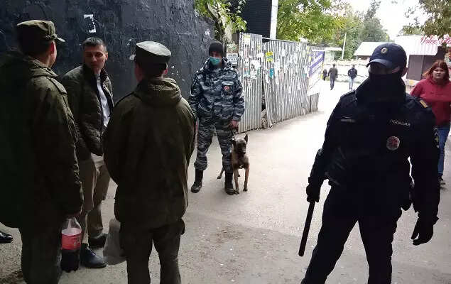 Law enforcement officers are seen near the scene of a shooting at university in Perm , 8 dead, several injured in shooting at Russian university, The World Live Breaking News Coverage & Updates IN ENGLISH