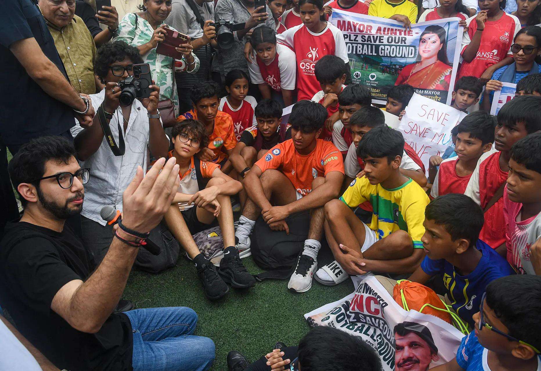 Aaditya Thackeray interacts with young protesters opposing the change in the reservation of the Neville D'Souza Football Ground to a "Convention Centre", in Mumbai. (PTI Photo)