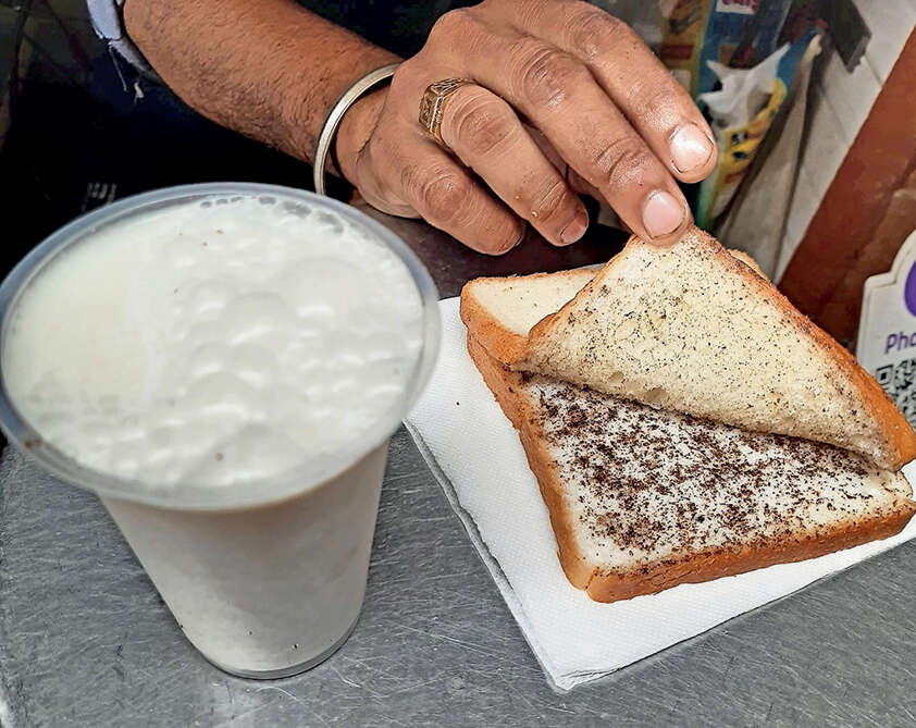 Freshly churned white butter with masala on bread and buttermilk<br>