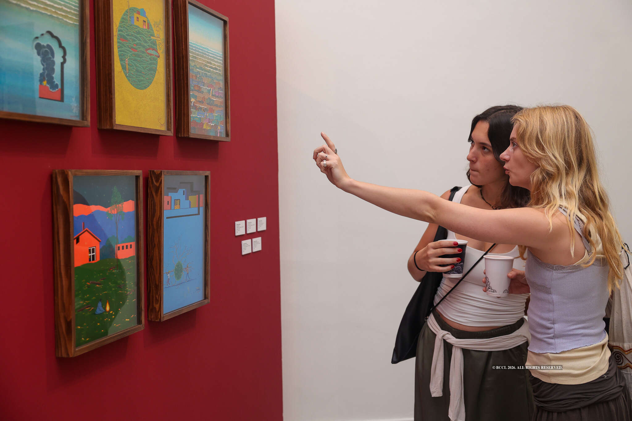 Attendees take a keen look at Digbijayee Khatua's artworks