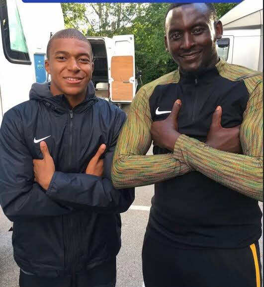 George Kamurasi with Kylian Mbappe
