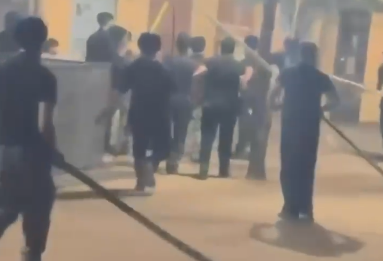 Video grab of bouncers attacking revellers with swords, sticks and chains at garba venue in Rancharda, Gandhinagar  (4).png