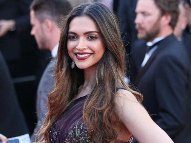 Deepika Padukone at Cannes: Piku star soars temperature in a sheer jewel-toned maroon outfit