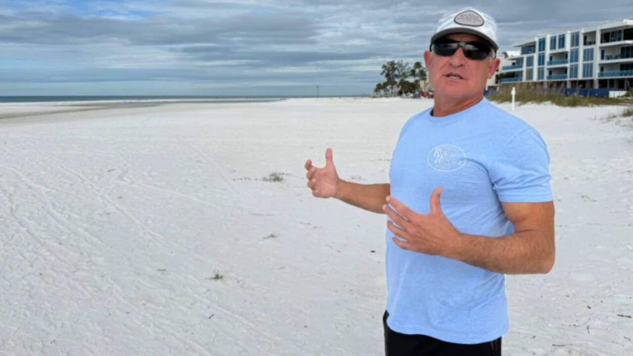 Holderness stands on one of the four beachfront lots he will trade to Sarasota County.