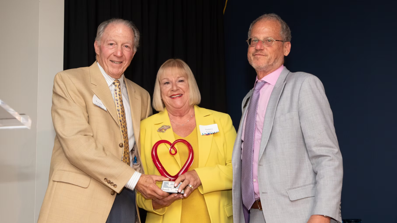 Ronald and Samra Robbins, founders of Backpack Buddies of Metro Atlanta, receive the Max & Mary London People Power Award from Jewish Federation of Greater Atlanta President & CEO Eric Robbins.