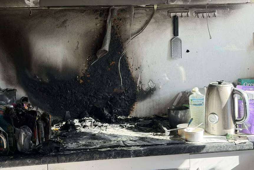 The young boy calmly alerted his mother after seeing flames reflected in a kitchen window.