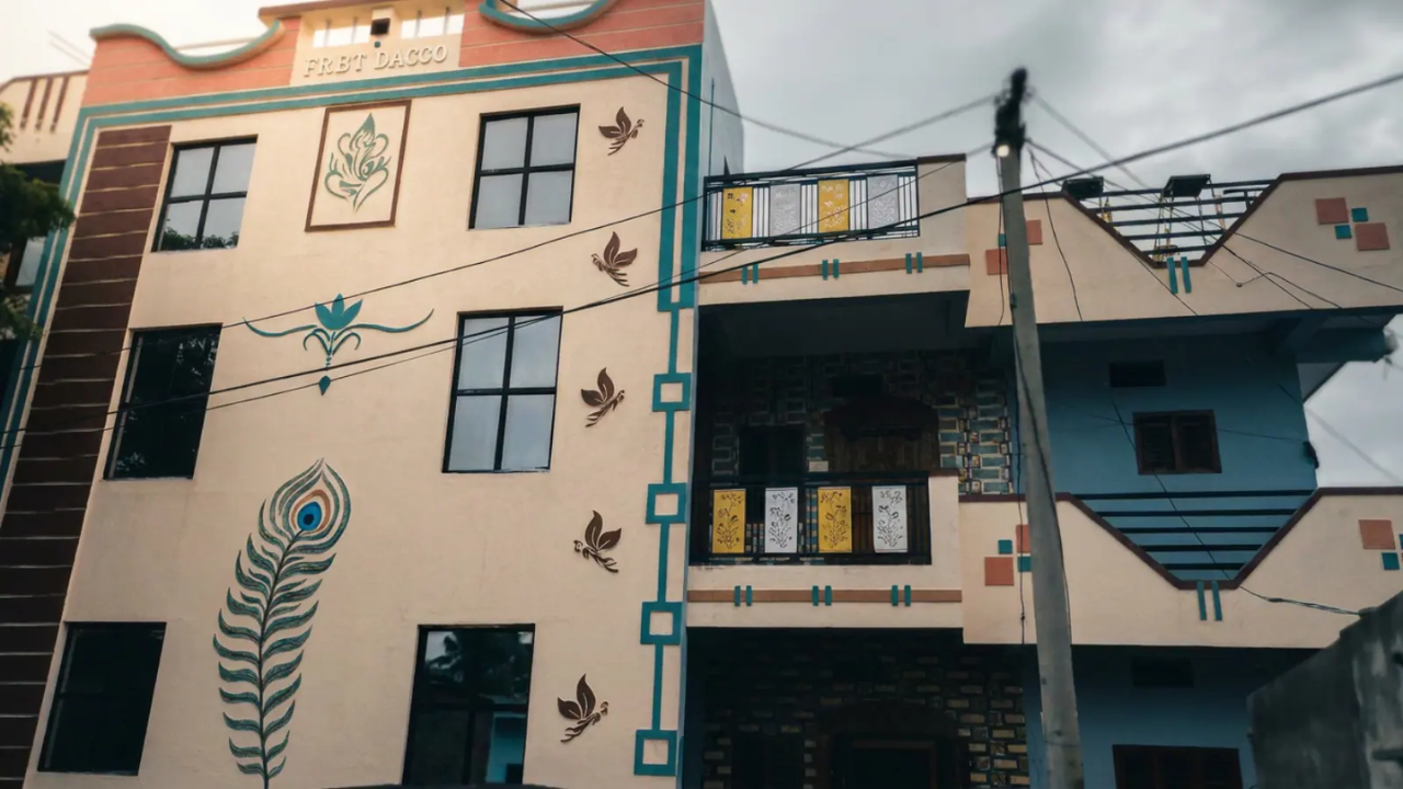 The family is spread across four houses rather than literally sharing one building.
