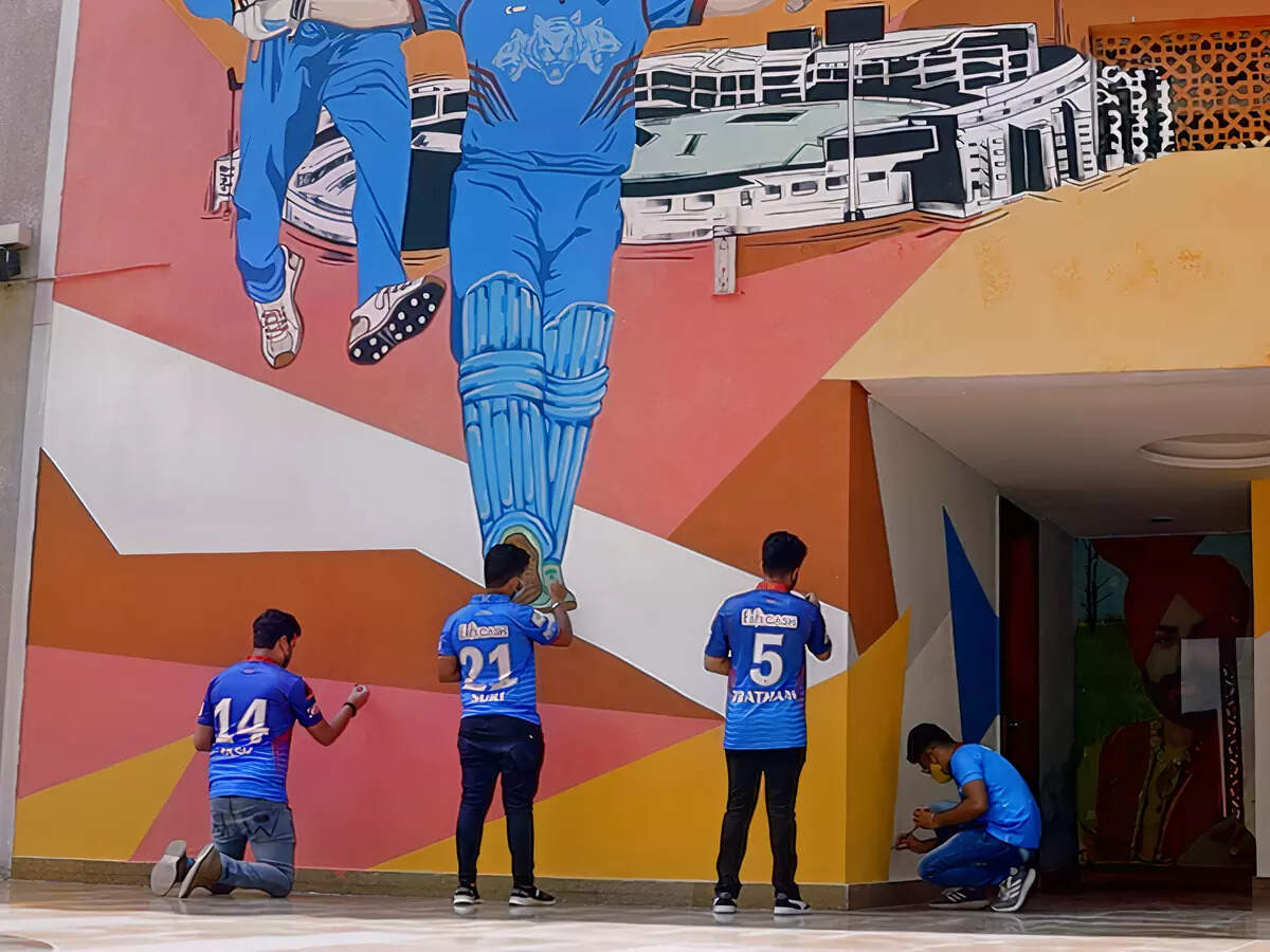 Cricket fans helping artistes put finishing touches on the mural