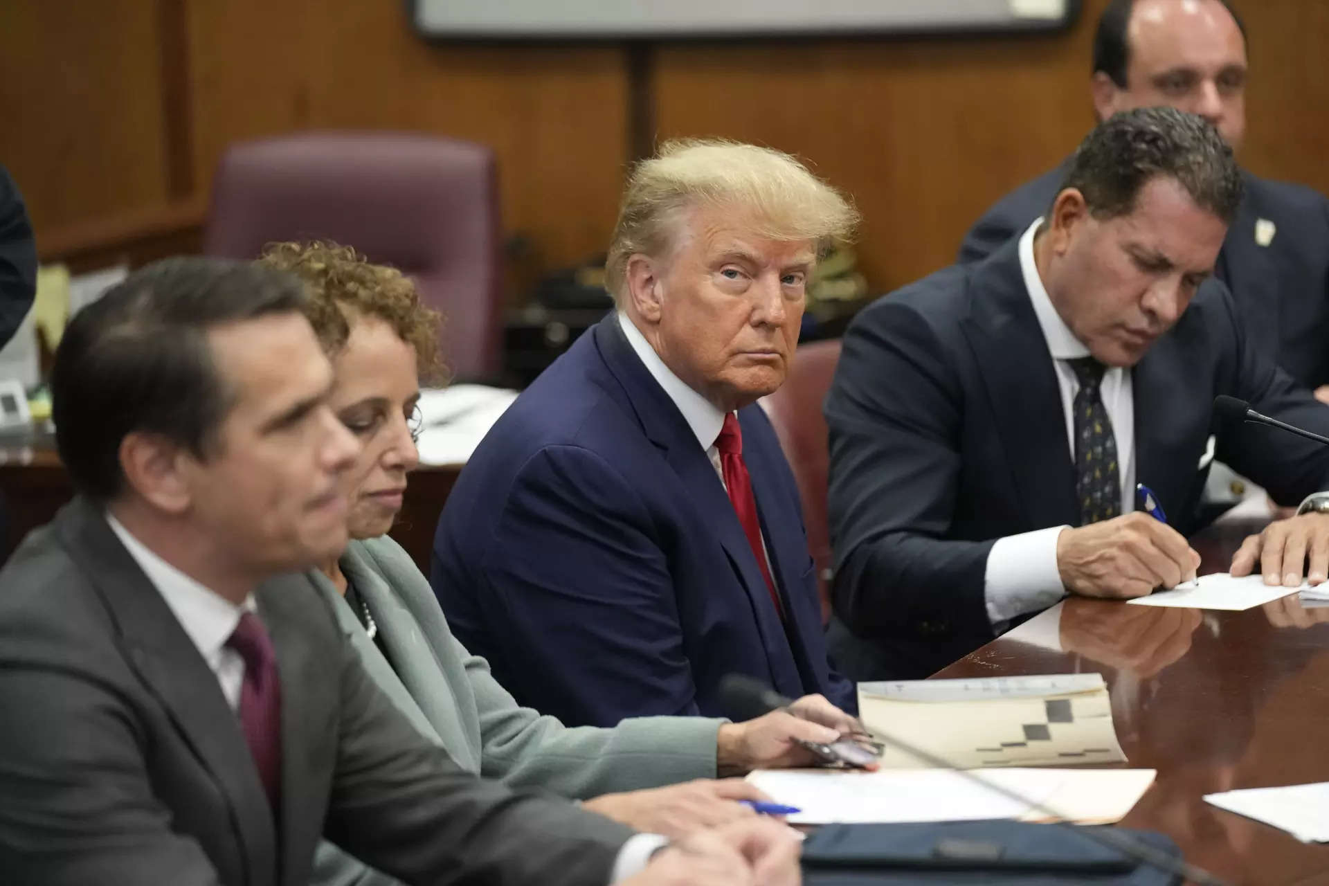 File photo:  Former President Donald Trump sits with his defense team in a Manhattan court. (AP Photo/Seth Wenig, Pool)