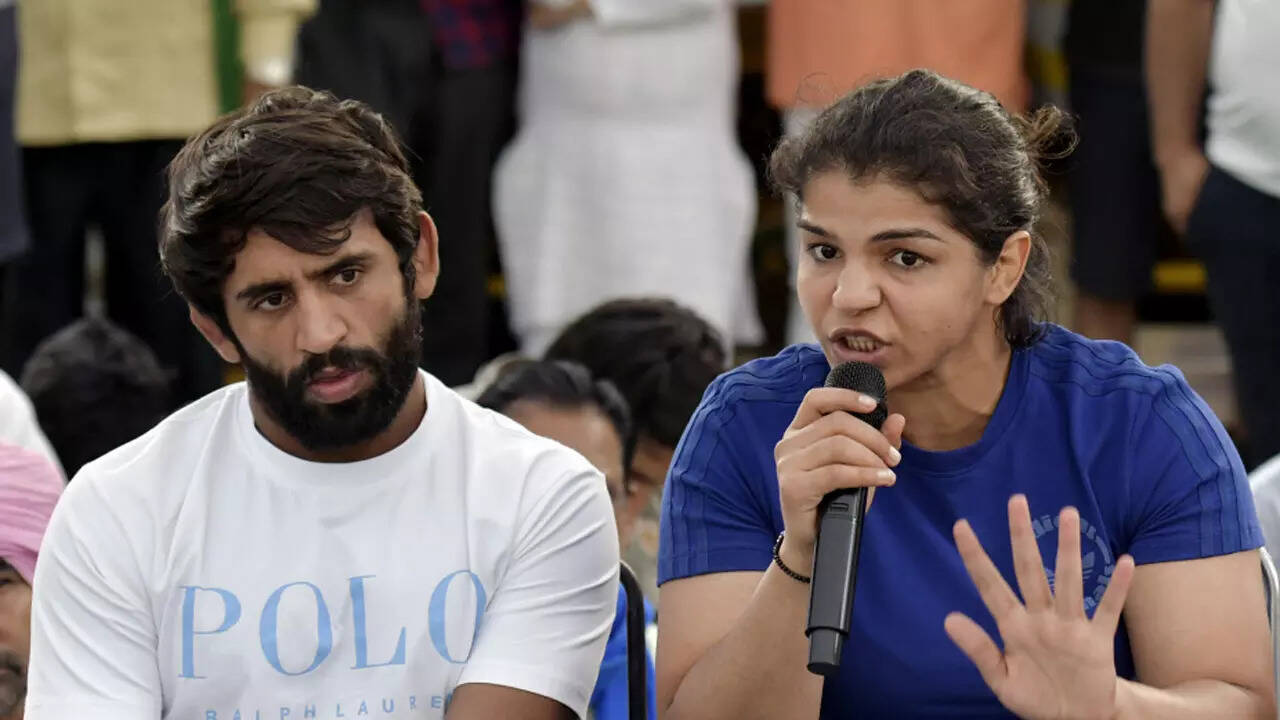 Wrestlers Bajrang Punia, Sakshi Malik meet sports minister for talks