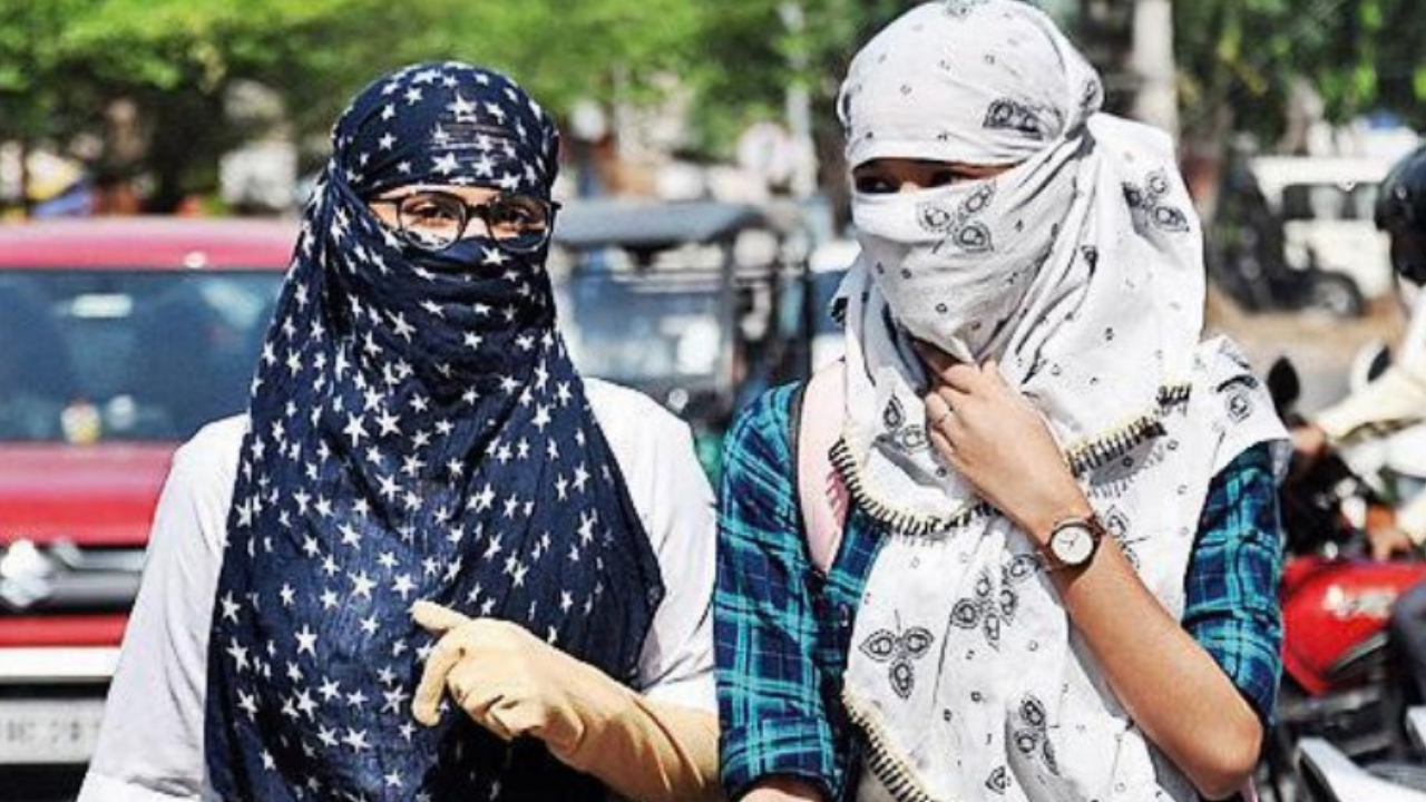 Girls protect themselves from heatwave in Patna on Saturday