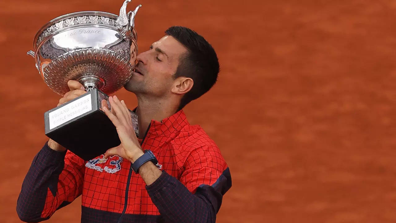 Novak Djokovic kisses his trophy as he celebrates his victory over Norway's Casper Ruud. (AFP Photo)