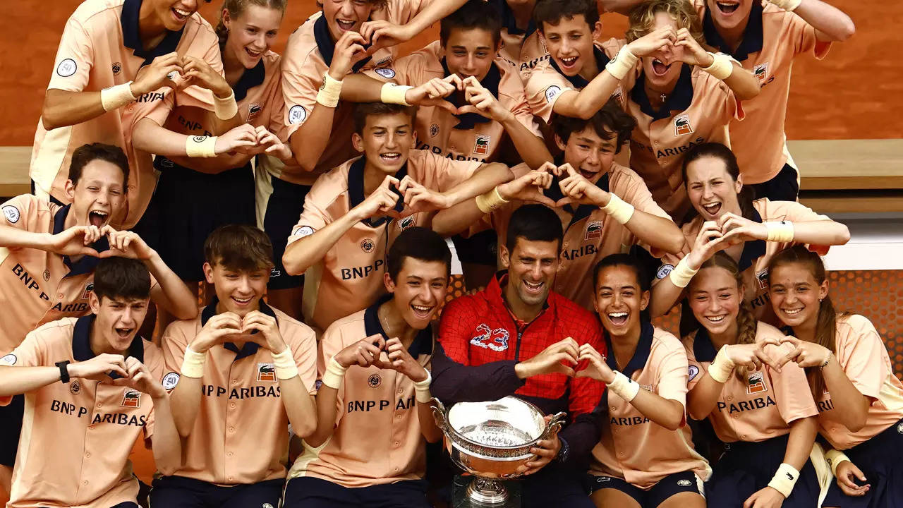 Novak Djokovic celebrates with the trophy and ball kids after winning the French Open. (Reuters Photo)