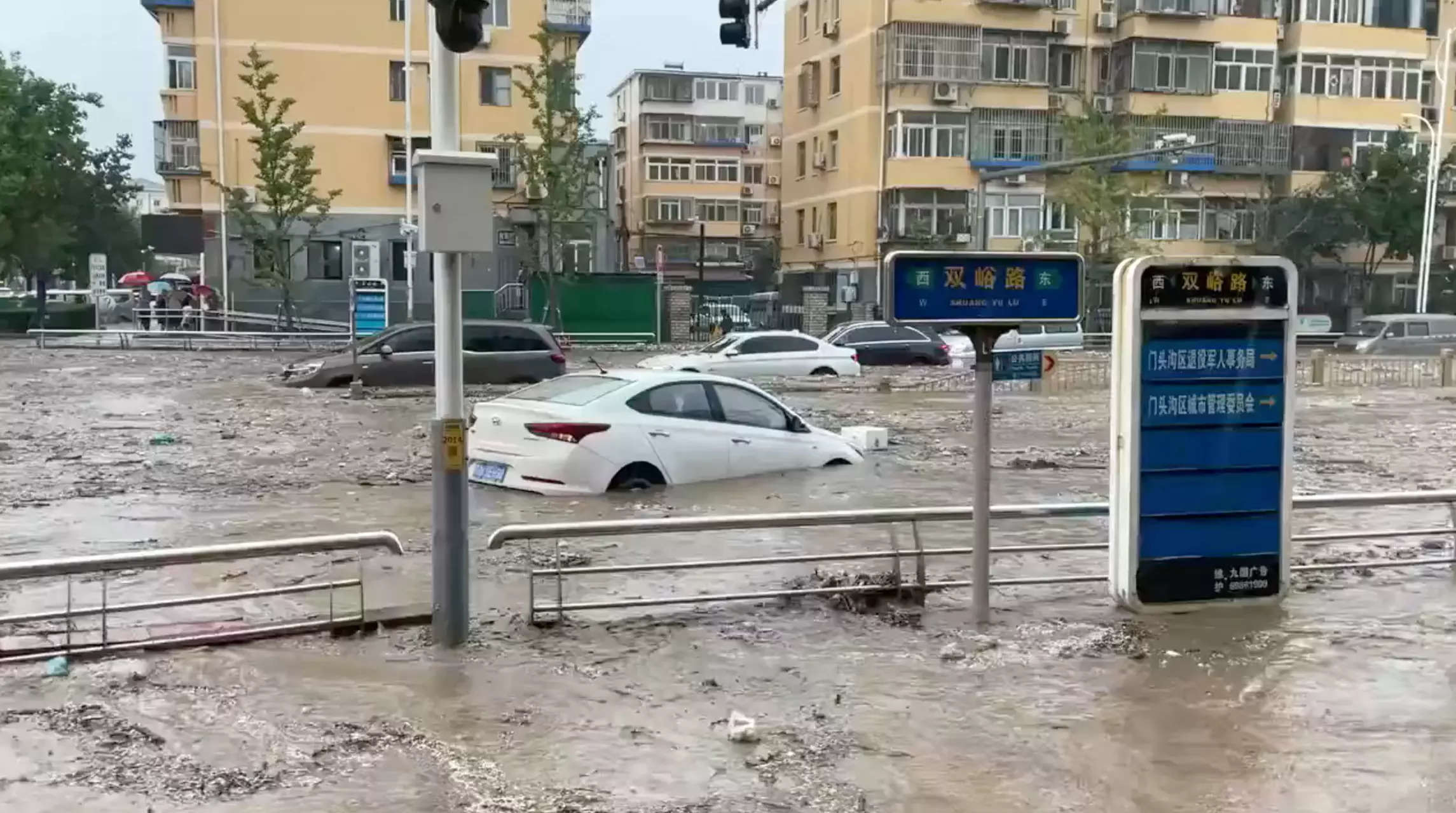 Beijing on alert with two killed as heavy rain batters China