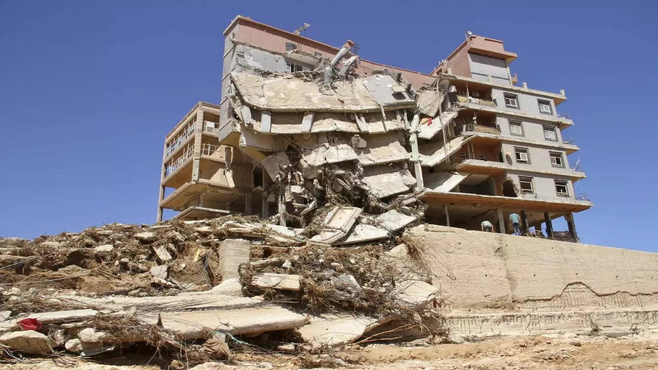 Libyan city buries thousands in mass graves after flood, while mayor says death toll could triple