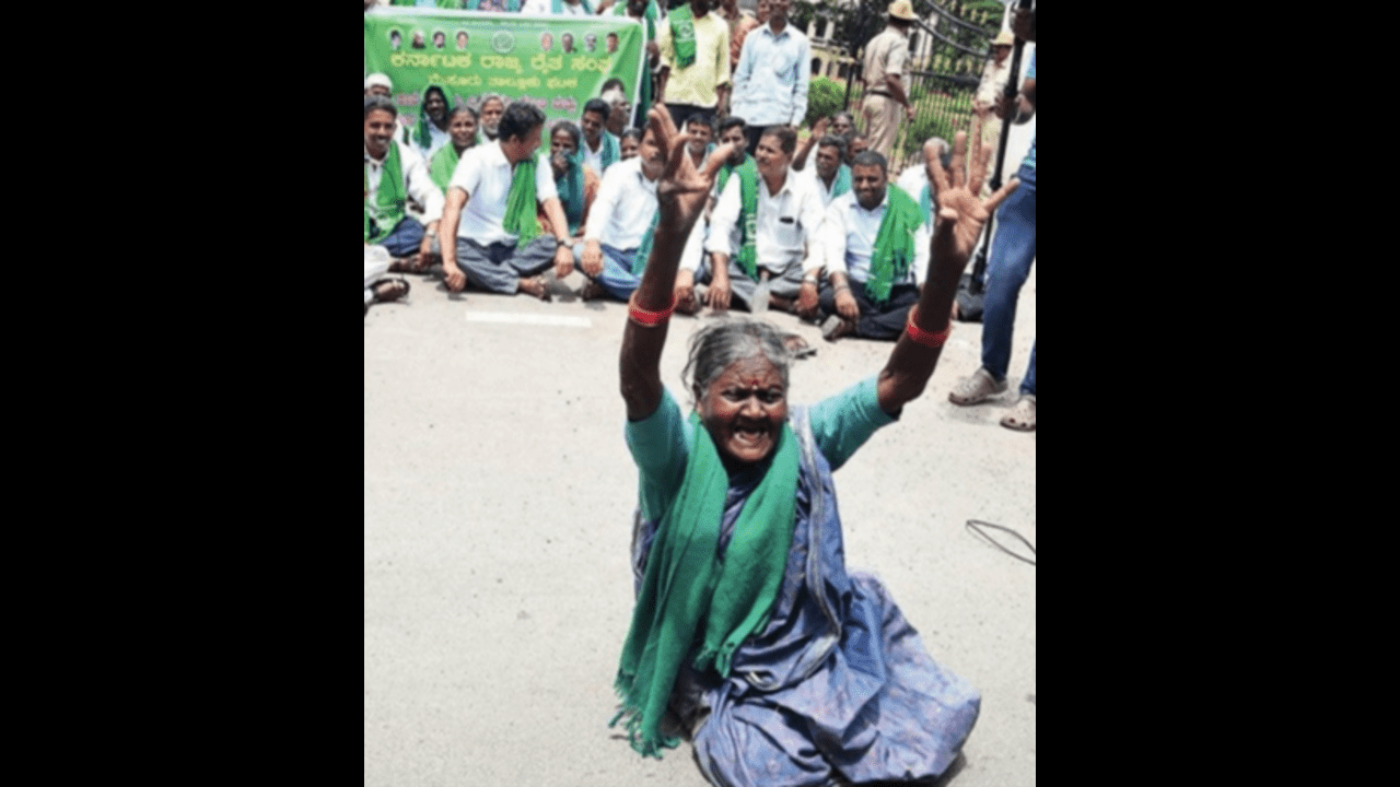 A farmer protests the release of Cauvery river water to Tamil Nadu in front of the Mysuru zilla panchayat office on Monday