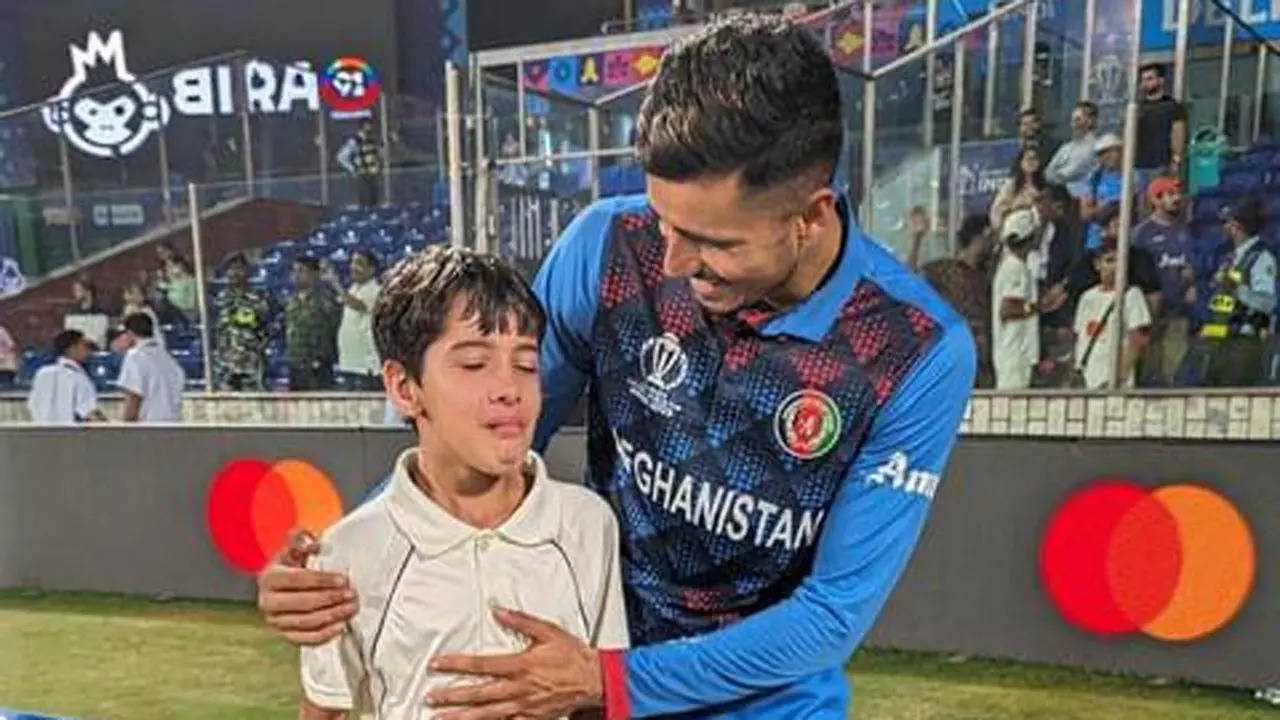 Afghanistan spinner Mujeeb Ur Rahman with a fan after match against England. (Photo credit: X)