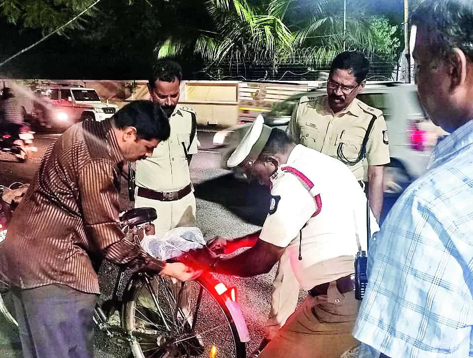 Cops stick reflectors on bicycles to ensure safety of cyclists