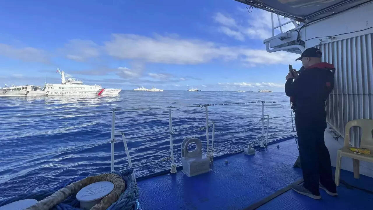 Dozens of Chinese ships chase Philippine vessels as US renews warning it will defend its treaty ally