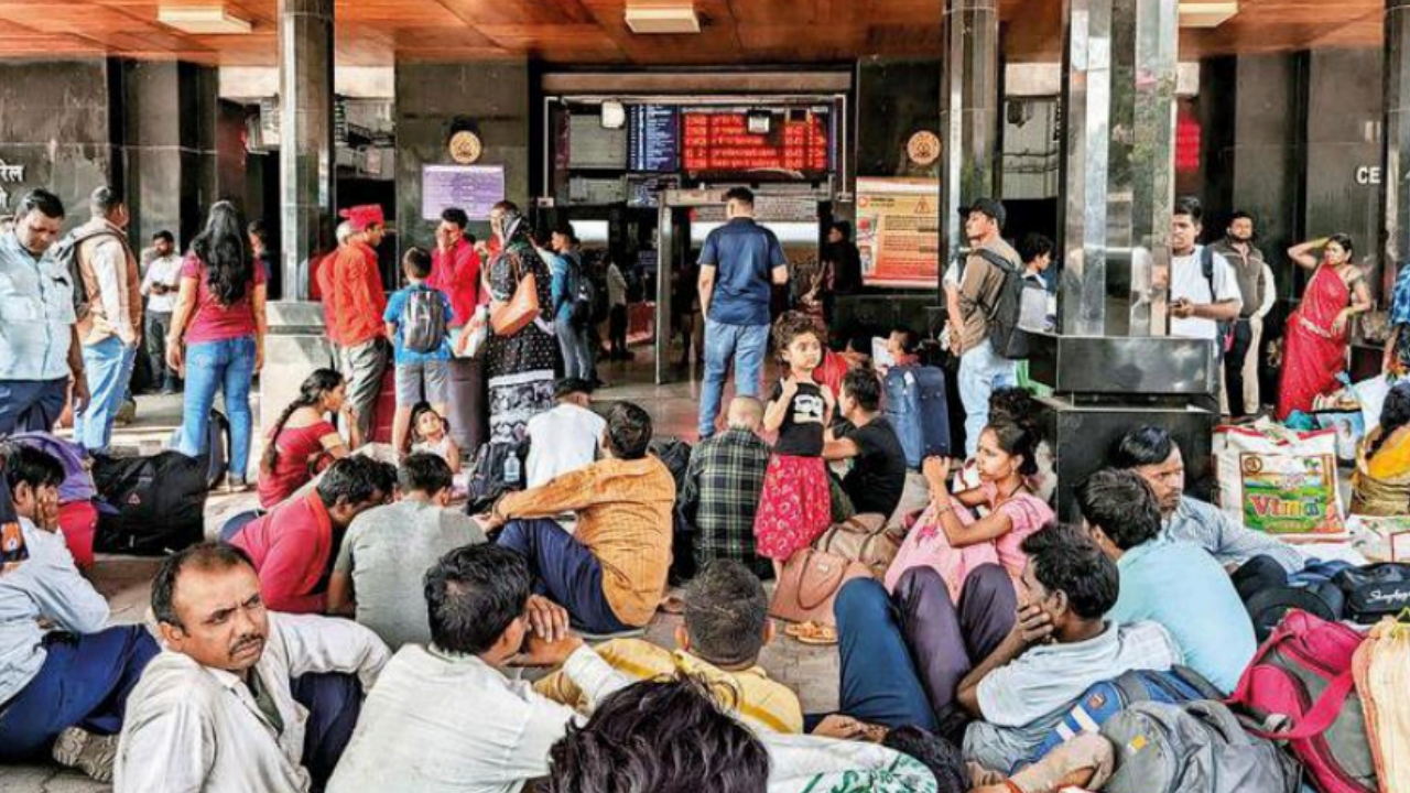 Commuters wait for their trains at Pune station on Sunday