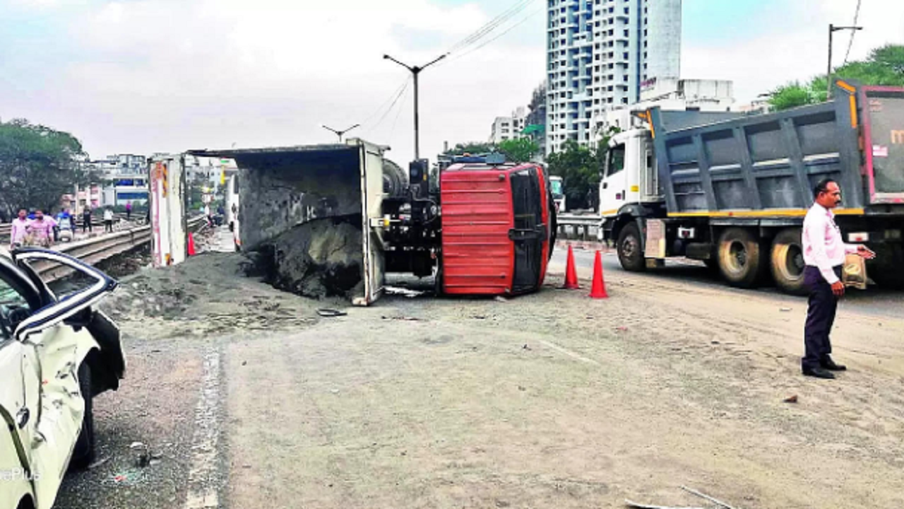The dumper on its side blocks the road 