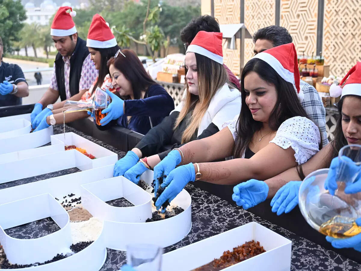 Guests enjoying cake mixing ceremony in Jaipur