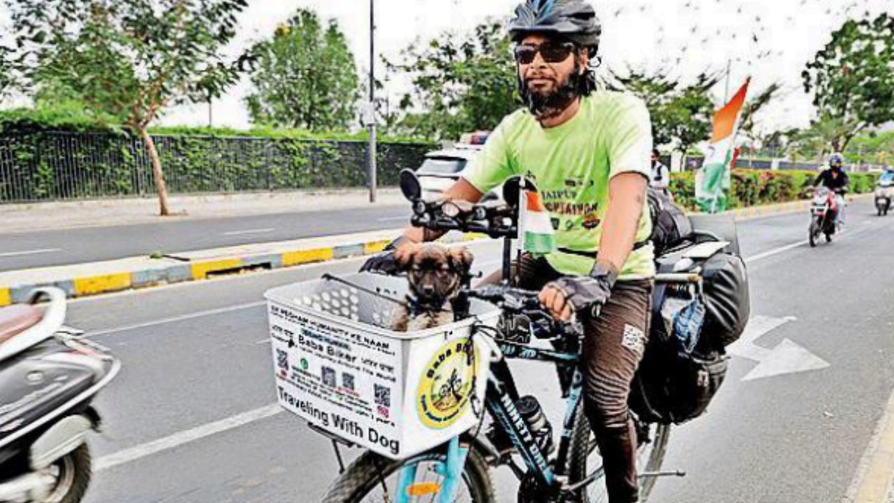 Cyclist on 42,000-km journey with his pup to ‘save humanity’ | Ahmedabad News – Times of India