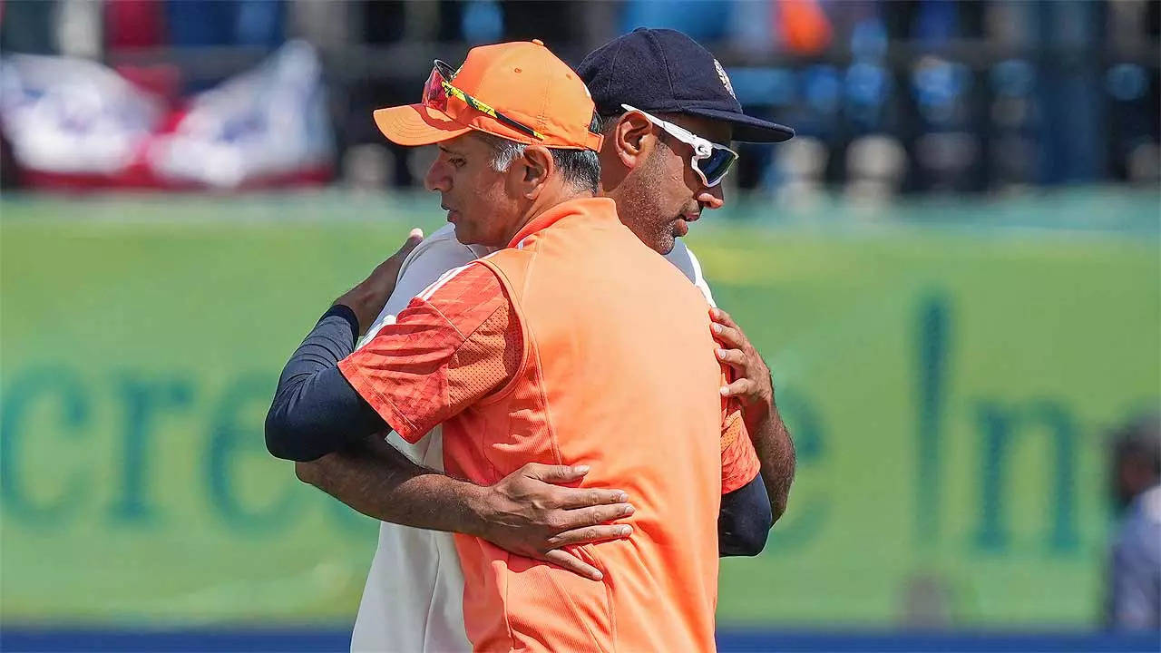 BOWLING, MATE! India coach Rahul Dravid congratulates Ravi Ashwin after the Dharamshala win on Saturday. (PTI Photo)