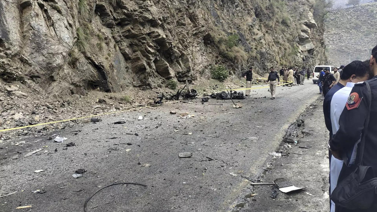 Police officers examine the site of suicide bombing at a highway in Shangla, a district in the Pakistan's Khyber Pakhtunkhwa province, Tuesday, March 26, 2024. (Photo/AP)