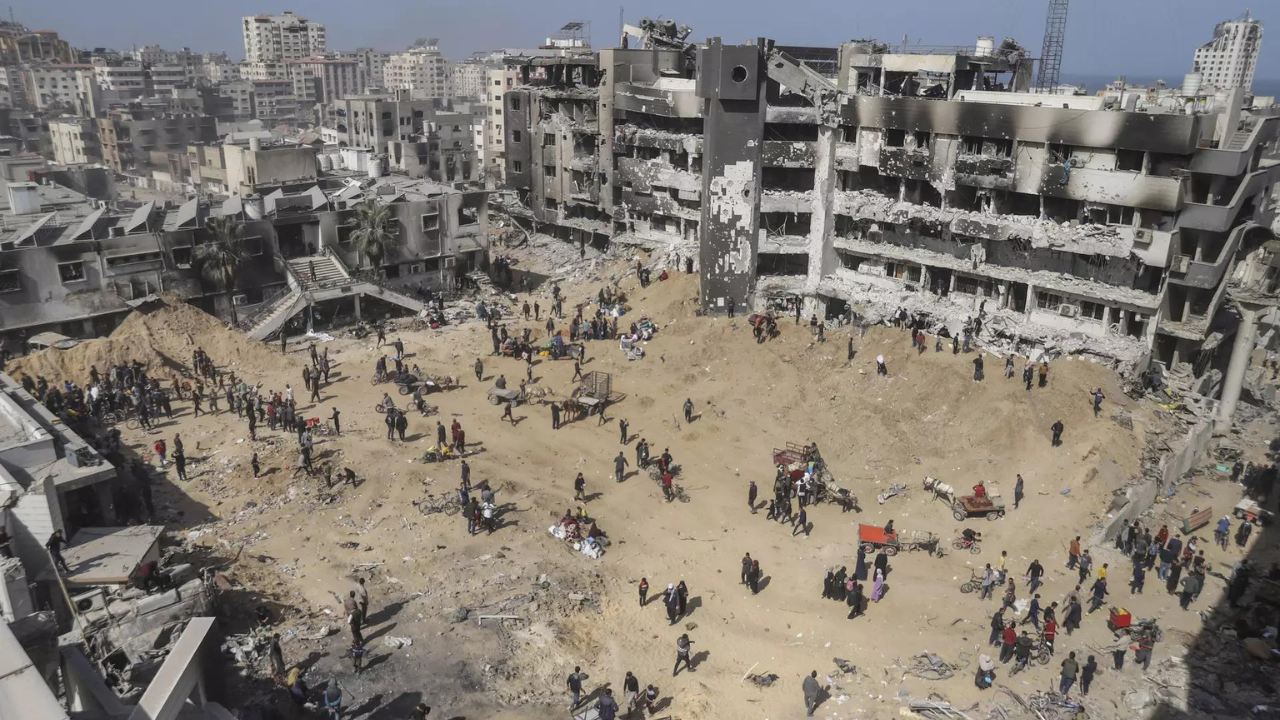 Palestinians walk through the destruction left by the Israeli air and ground offensive on the Gaza Strip near Shifa Hospital in Gaza City, Monday, April 1, 2024. (Photo/AP)a