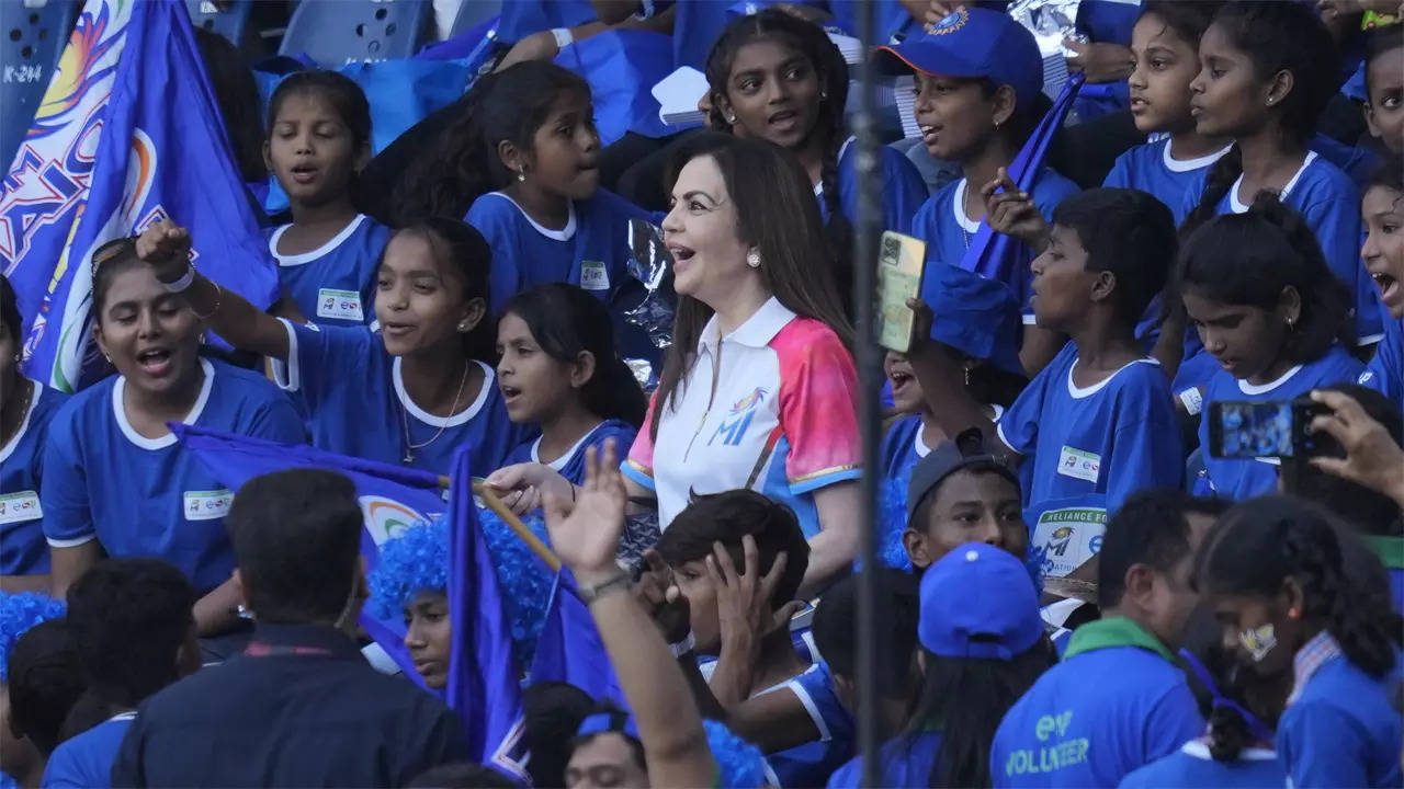 Nita Ambani, centre, reacts as she watches the IPL match between Mumbai Indians and Delhi Capitals with children in Mumbai. (AP Photo)